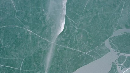 Ice patterns on a frozen lake surface - Powered by Adobe