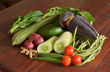 Fresh exotic vegetables on the brown table, raw vegetables from Asian market