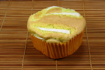 Traditional baked muffin cake topping with coconut meat.