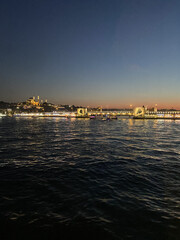 Obraz premium Istanbul City Ferry with sunset over Bosphorus. Golden sky over Bosphorus, Istanbul