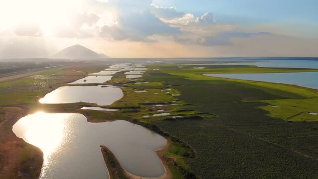Aerial view of Dau Tieng lake, Tay Ninh province, Vietnam. Blue sky and clear water. Stunning views. This is also a famous tourist destination. Ba Den mountain in cloud.