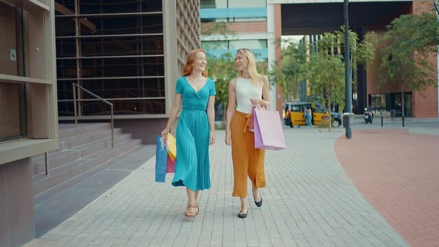 Cinematic storytelling footage of two north european beautiful young women having fun outdoor, making shopping and spending time together. 