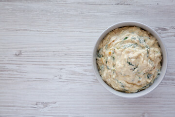 Homemade Caramelized Onion and Spinach Dip with Salty Round Crackers, top view. Flat lay, overhead, from above. Copy space.
