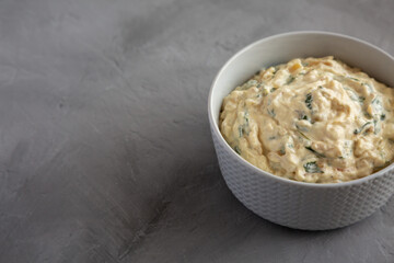 Homemade Caramelized Onion and Spinach Dip, side view. Copy space.
