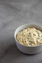 Homemade Caramelized Onion and Spinach Dip, side view. Copy space.