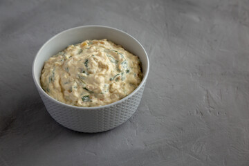 Homemade Caramelized Onion and Spinach Dip, side view. Space for text.