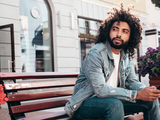 Handsome smiling hipster  model.Sexy unshaven Arabian man dressed in summer jeans jacket clothes....