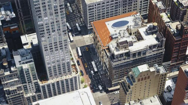 Top view of an urban area of Manhattan on a sunny day with traffic in the streets, static shot.