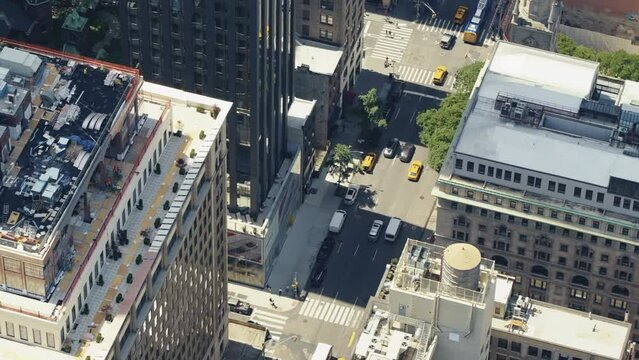 Top view of an urban area of Manhattan on a sunny day with a lot of yellow taxis in the streets, static shot.