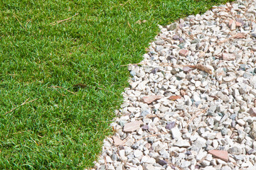 Detail of a beautiful green mowed lawn with white gravel - obrazy, fototapety, plakaty
