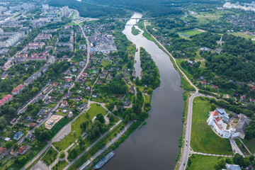 aerial view from great height on wide river and huge bridge of old city