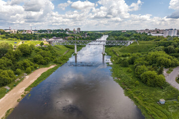 Fototapeta premium aerial view from great height on wide river and huge bridge of old city