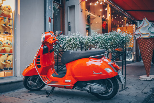 Red motorcycle at the entrance to the cafe. Atmospheric street photo