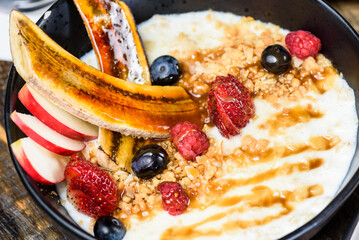 A healthy bowl of porridge and fruit for a vibrant fresh breakfast
