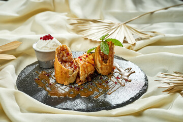 Apple strudel on slate. Hard light. Selective focus. Close-up