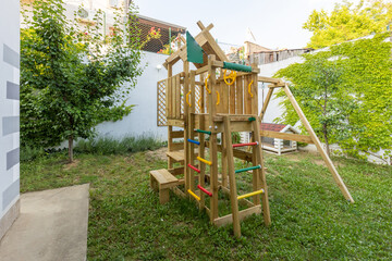 Outdoor wooden playground in the summer