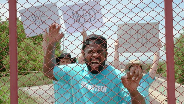 Portrait Of The African American Man Being Among Crowd Marched Holding Fight For Climate Change And Loking With Serious And Angry Face To The Camera, Global Warming Concept