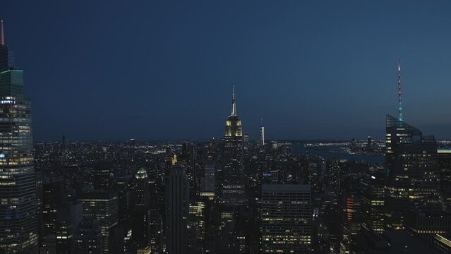 Manhattan and the Empire State Building at night, with illuminations on its top, wide angle and static shot.