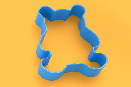 Metal cookie cutters for homemade Christmas biscuit on a yellow background.
