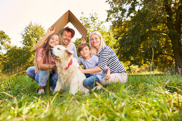 Happy family holding a roof over their heads