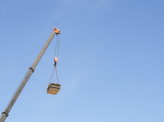 crane boom, construction crane with a load at a height