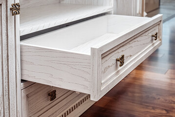 Built-in chest of drawers from veneer and solid ash in light enamel with gray patina. Detail of...