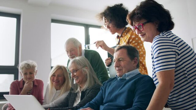 Group of senior people attending computer and technology education class.