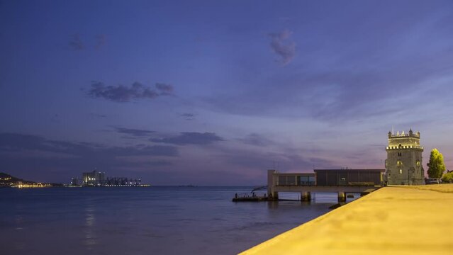 Torre de Bel&eacute;m / Belem Tower in Lisboa at dusk with Port of Trafaria time lapse