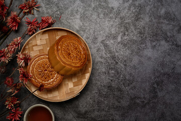 Chinese traditional mid autumn festival moon cake on rustic black background with copy space