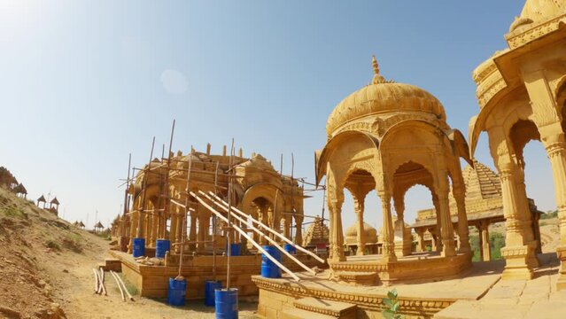 4K Wide angle shot of chattri cenotaph of Bada bagh under repairs at Jaisalmer in Rajasthan, India. Old architecture undergoing repairs and restoration. Old monuments being repaired to preserve it. 