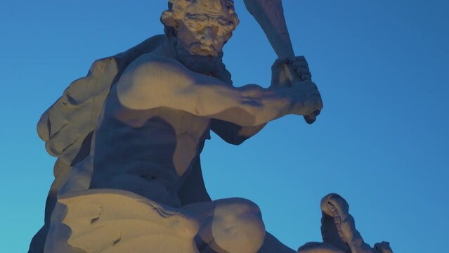 Sculpture of a Man Battling a Mythical Creature with a Club (Karlsruhe, Germany)
