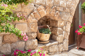 Fototapeta na wymiar A decorative broken plant pot is found in a niche in the Arab Christian village Miilya, in the Galilee, in northern Israel