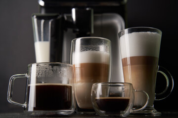 Group of cup with different freshly types of coffee: cappuccino, latte and espresso.
