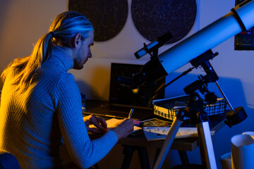 Astronomer man do astronomy work. Telescope pointing on the night sky, space, cosmos, universe,...