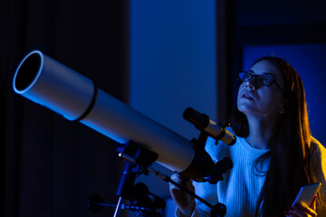 Astronomer woman looks through telescope at night sky, space, cosmos, universe, Milky way. Female scientist watching the stars and Moon with professional telescope at a summer day. Do astronomy work