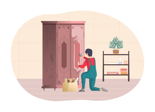 Male professional restore restoring old vintage wooden wardrobe. Craftsman repairing retro furniture and cleaning wood of closet with brush.