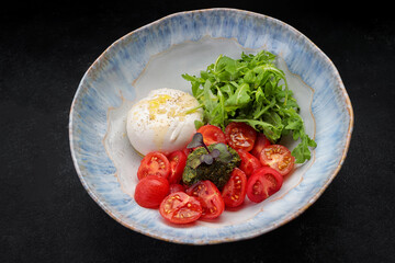 Burrata with arugula, cherry tomatoes and pesto sauce