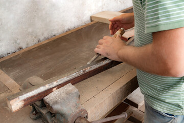 Man assembling furniture and fixing it - hobby garage concept.