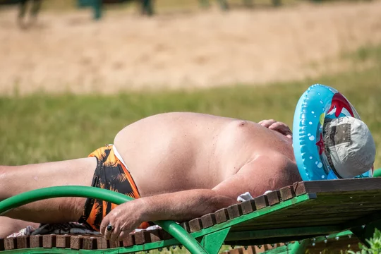 fat man body positive rest in the beach meme Stock Adobe Stock