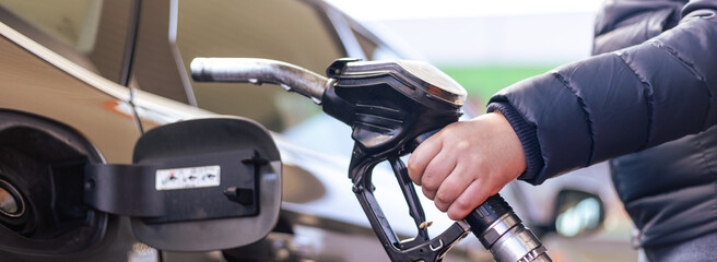 Refueling the car at a gas station fuel pump, car refueling on petrol station, fuel pump at station
