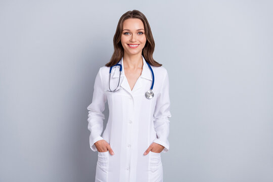 Photo Of Experienced Lady Virologist Paramedic Put Hands Pockets Prevent Covid Infection Isolated Grey Color Background