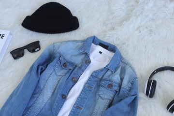 Set of stylish clothes: blue denim jacket and white t-shirt with headphone, beanie, and sunglasses - Powered by Adobe