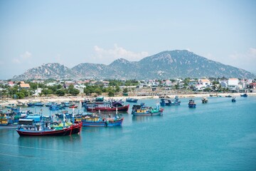 Fototapeta na wymiar Landscape photo: fishing boats along the coast of Vinh Hy Bay. Time: June 20, 2022. Location: Phan Rang City. 