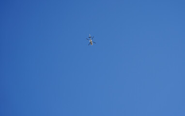 helicopter in flight with blue background.