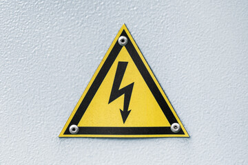 Triangular yellow sign of dangerous electrical voltage