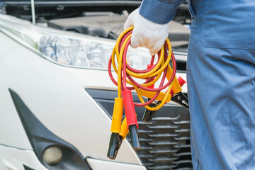 Car service, repair, maintenance concept. Close up of hands  electrician repairs car, tester and...
