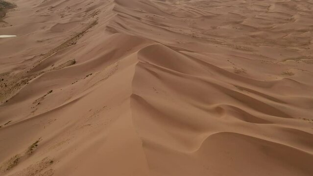 Backward aerial view of goby desert sand dunes, mongolia