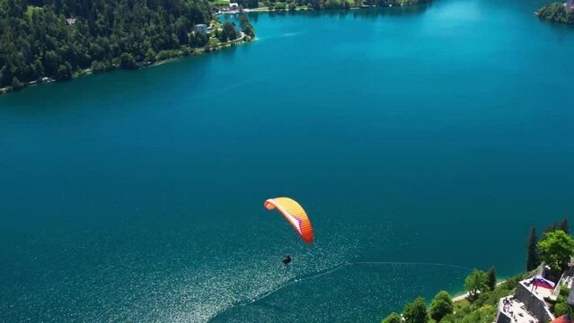 Paragliders over Lake Bled, Slovenia. Beautiful lake and forest, drone view. 