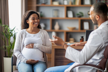 Pregnant african american woman visiting doctor at clinic