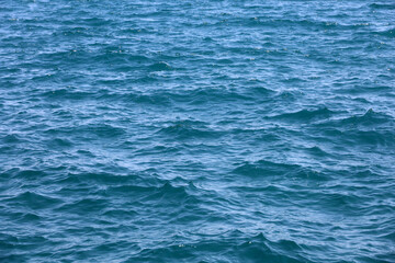 Fototapeta premium Water surface of deep blue sea. Soft waves texture, ripple water for background